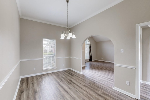 1720 Willow Crk, Mesquite, TX 75181 - spare room with baseboards, arched walkways, a chandelier, and wood finished floors