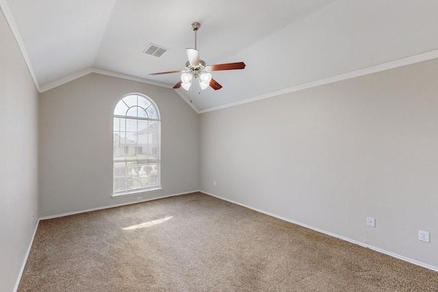 empty room with lofted ceiling, carpet floors, ornamental molding, and ceiling fan