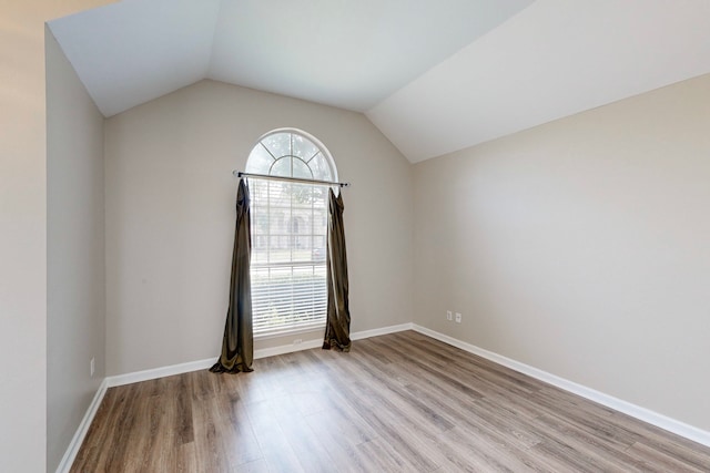 1720 Willow Crk, Mesquite, TX 75181 - empty room featuring baseboards, vaulted ceiling, and wood finished floors