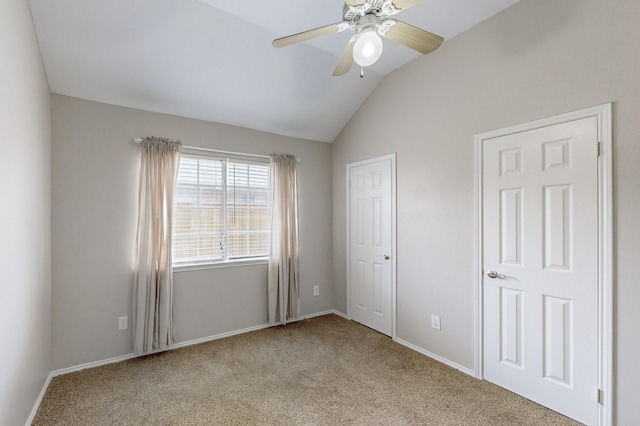 unfurnished bedroom with vaulted ceiling, light colored carpet, and ceiling fan