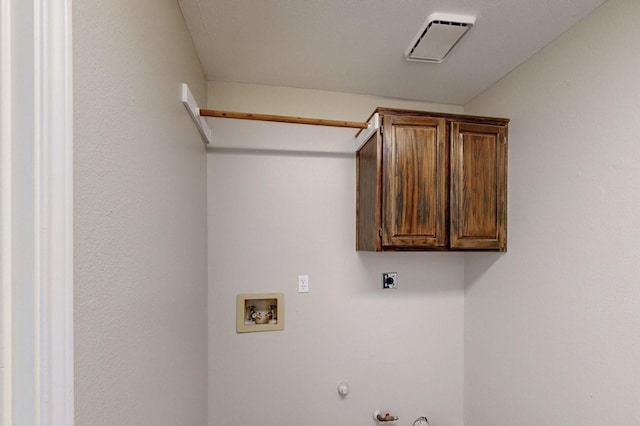 laundry room featuring hookup for a washing machine, gas dryer hookup, electric dryer hookup, and cabinets