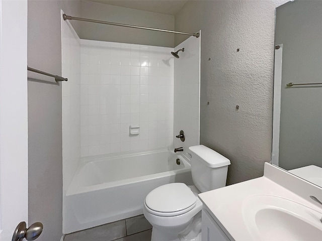 full bathroom featuring vanity, tiled shower / bath, and toilet