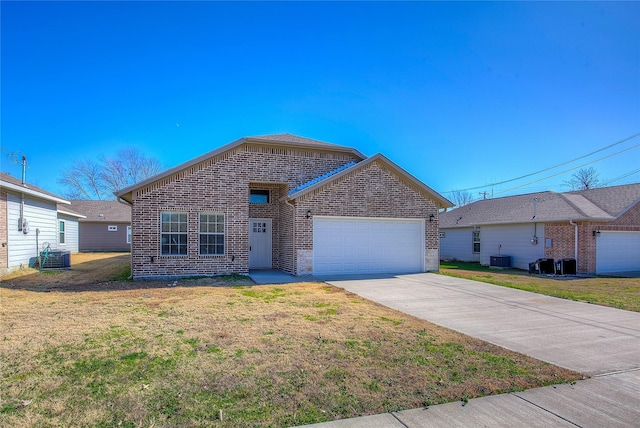 view of front of home with a garage, cooling unit, and a front lawn