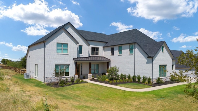 view of front facade featuring central AC unit, a front lawn, and a porch