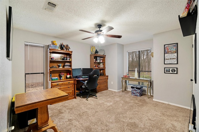 office with ceiling fan, light colored carpet, and a textured ceiling