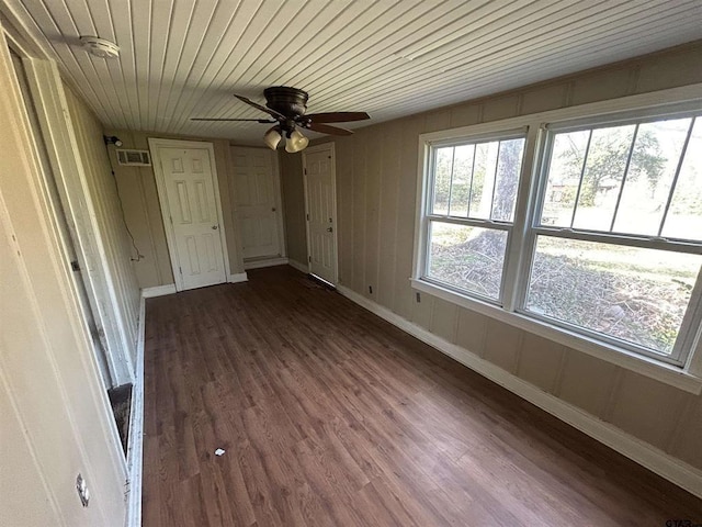 interior space featuring ceiling fan, dark wood-type flooring, and wood ceiling