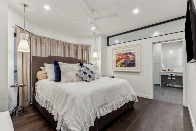 bedroom featuring built in desk, dark wood-type flooring, and ceiling fan