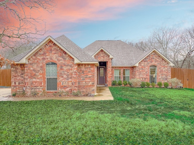 ranch-style house featuring a yard