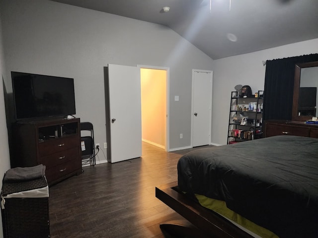 bedroom with lofted ceiling and dark hardwood / wood-style flooring