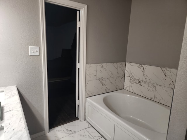 bathroom with vanity and a tub to relax in