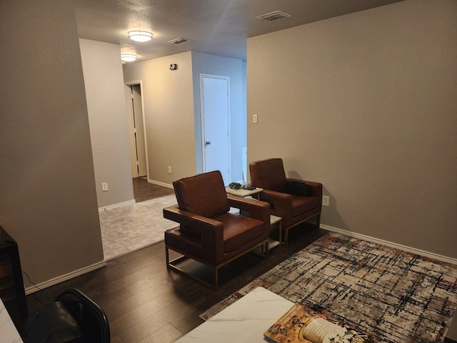 sitting room featuring dark hardwood / wood-style flooring