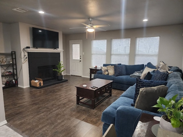 living room with dark hardwood / wood-style floors and ceiling fan