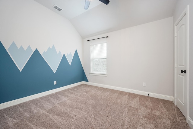 carpeted spare room featuring lofted ceiling, ceiling fan, visible vents, and baseboards