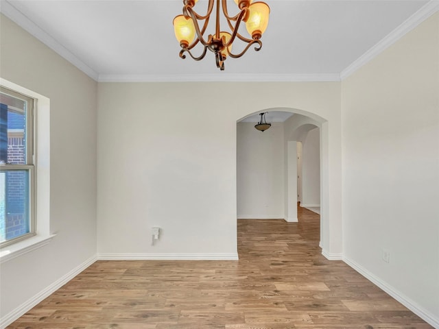 unfurnished room featuring crown molding, plenty of natural light, and light wood-type flooring