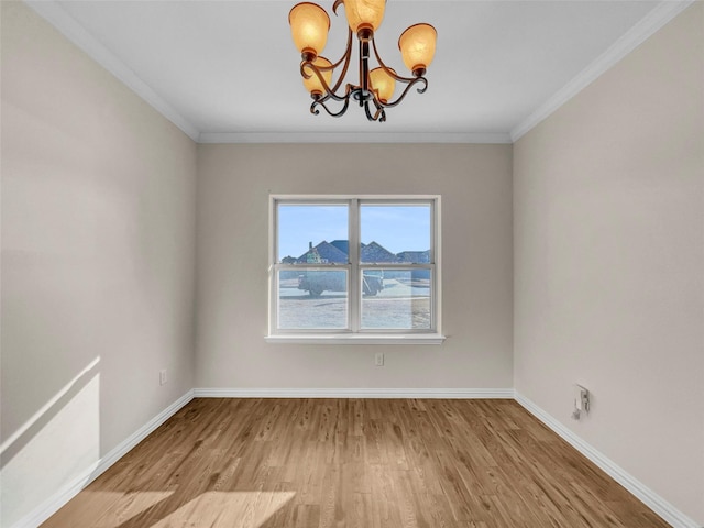 empty room featuring ornamental molding, light wood-type flooring, and a notable chandelier