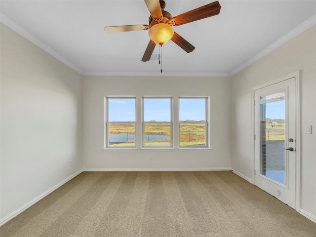 carpeted spare room with a water view, ceiling fan, and ornamental molding