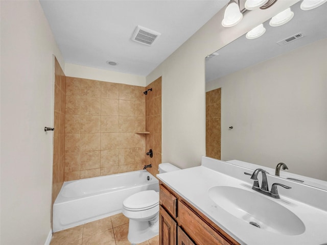 full bathroom featuring tiled shower / bath combo, vanity, tile patterned floors, and toilet