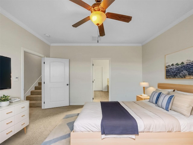 carpeted bedroom featuring crown molding and ceiling fan