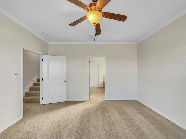 interior space featuring crown molding, light colored carpet, and ceiling fan