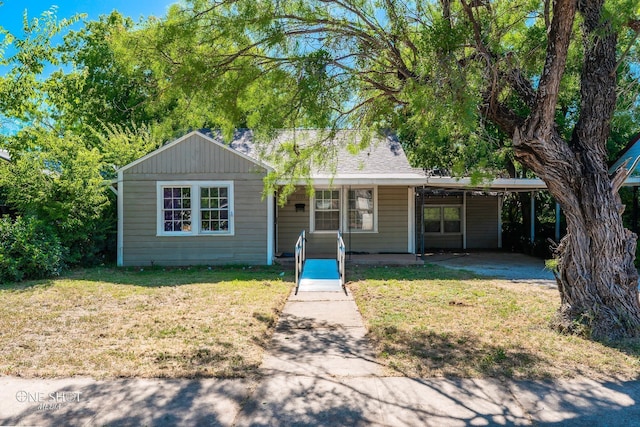 ranch-style house with a carport and a front lawn