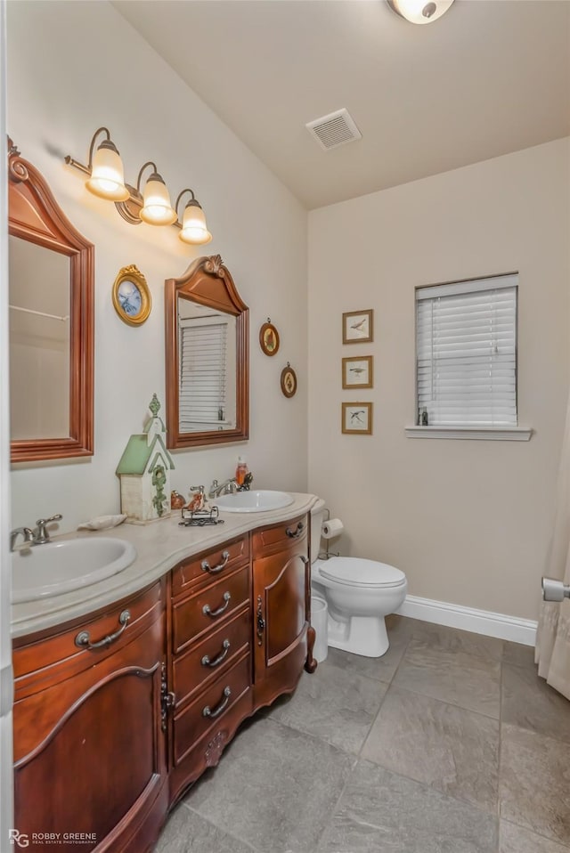 bathroom with vanity and toilet