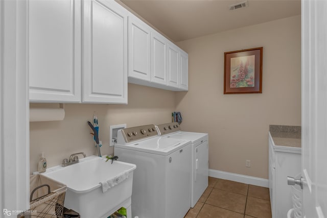 laundry room featuring independent washer and dryer, cabinets, light tile patterned flooring, and sink