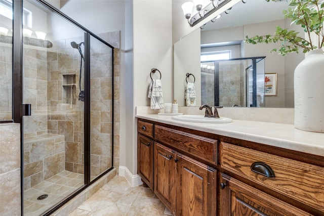 bathroom with vanity and a shower with shower door