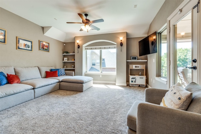 carpeted living room with ceiling fan