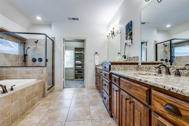 bathroom featuring tile patterned floors, vanity, and plus walk in shower