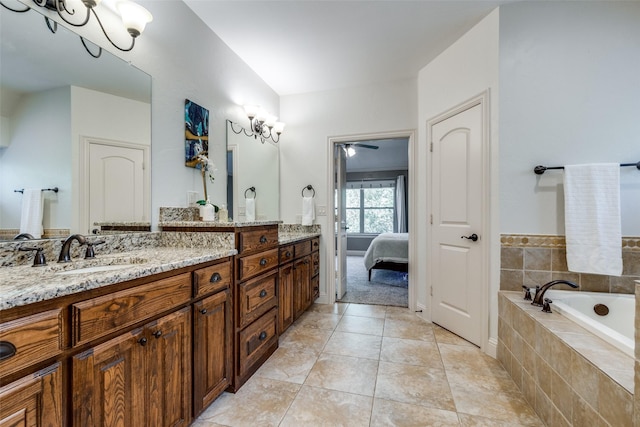 bathroom featuring vanity, tiled tub, and tile patterned floors