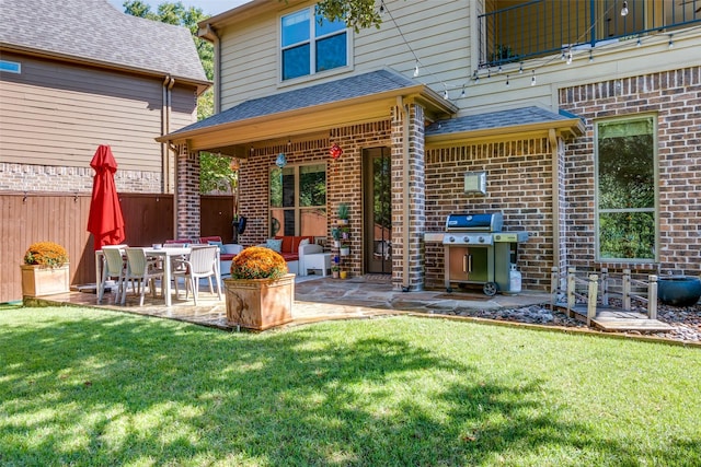 rear view of house featuring a yard and a patio area