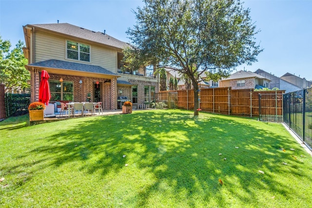 back of house featuring a lawn and a patio