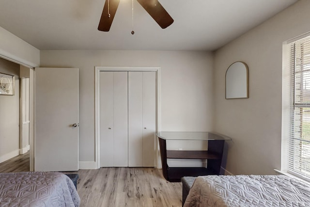 bedroom featuring ceiling fan, light hardwood / wood-style floors, and a closet