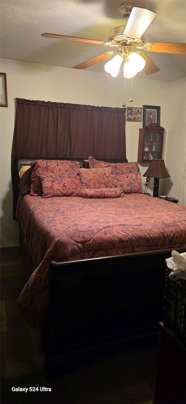 bedroom with a textured ceiling and ceiling fan