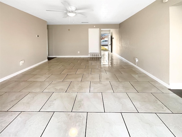 empty room with light tile patterned flooring and ceiling fan