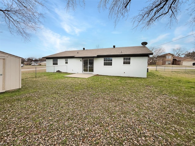 back of house featuring a storage shed, a yard, and a patio area