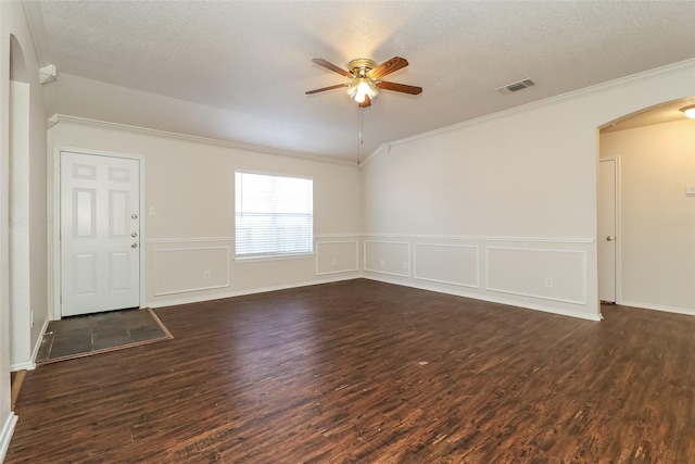 unfurnished room with dark wood-type flooring, ceiling fan, crown molding, and a textured ceiling