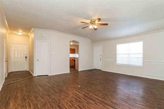 unfurnished living room featuring dark hardwood / wood-style flooring, ceiling fan, ornamental molding, and a textured ceiling