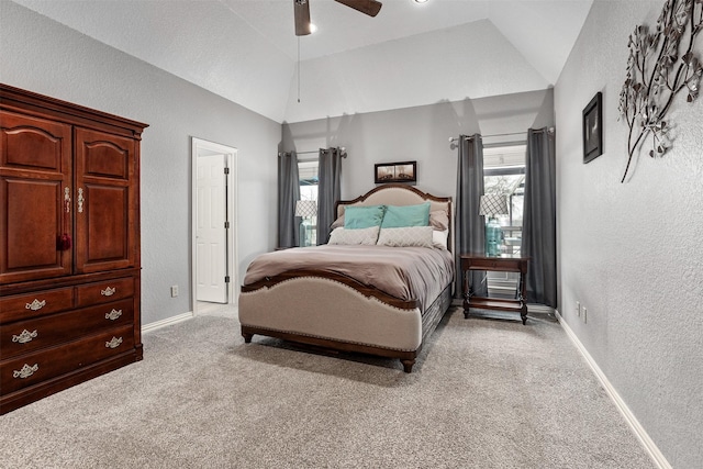 bedroom featuring vaulted ceiling, light colored carpet, and ceiling fan