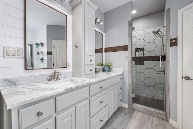 bathroom featuring walk in shower and vanity