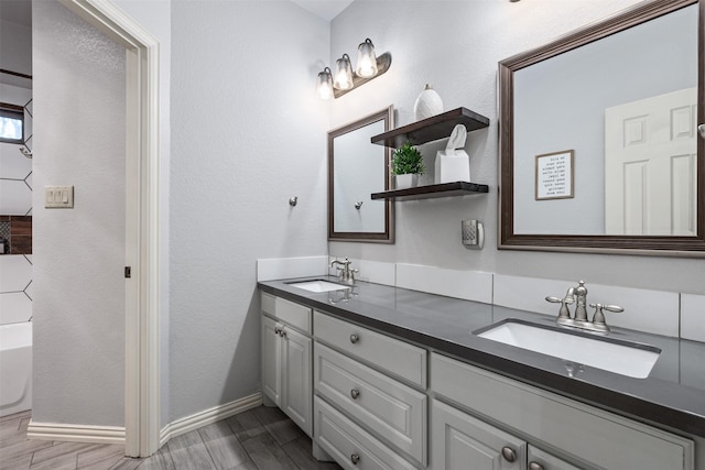 bathroom with vanity and a tub