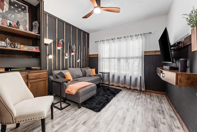 living area with light hardwood / wood-style flooring and ceiling fan