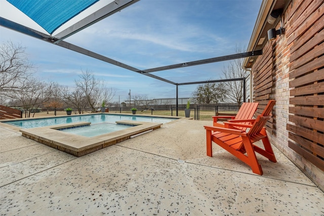 view of swimming pool featuring a patio, glass enclosure, and an in ground hot tub