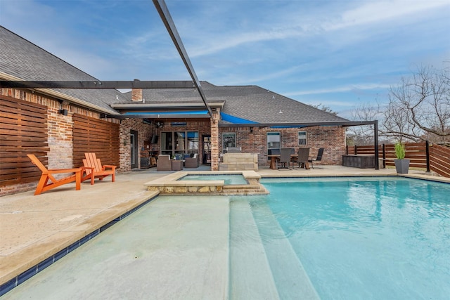 view of swimming pool featuring an in ground hot tub and a patio area