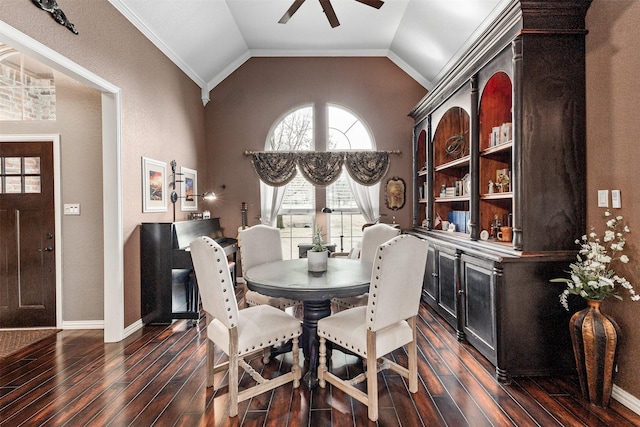 dining area with dark hardwood / wood-style flooring, vaulted ceiling, and ceiling fan