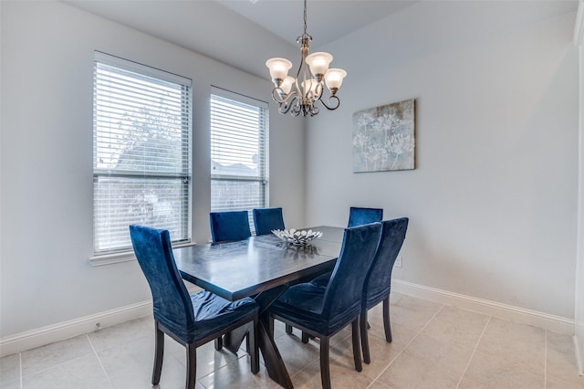 tiled dining room featuring a chandelier