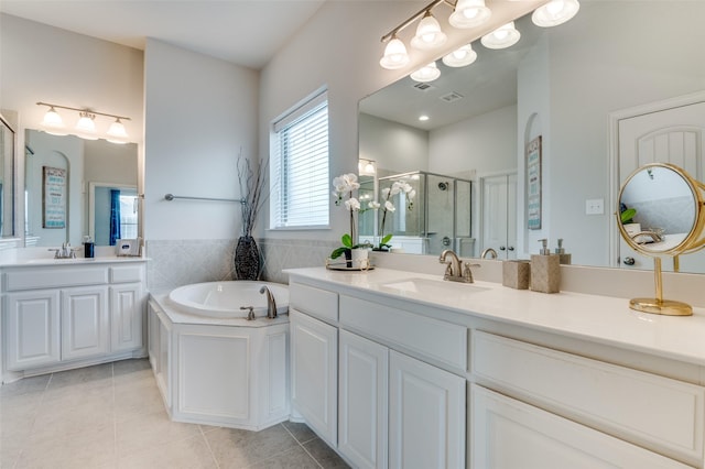 bathroom featuring vanity, independent shower and bath, and tile patterned flooring