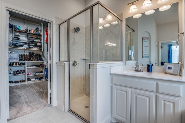 bathroom featuring an enclosed shower, vanity, and tile patterned floors