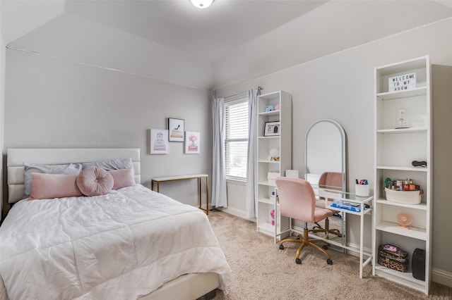 bedroom with vaulted ceiling and light carpet