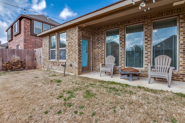 back of house with a patio and an outdoor fire pit